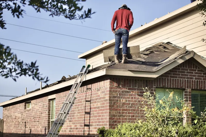 Professional roofer working on a residential roof in Parker Lane